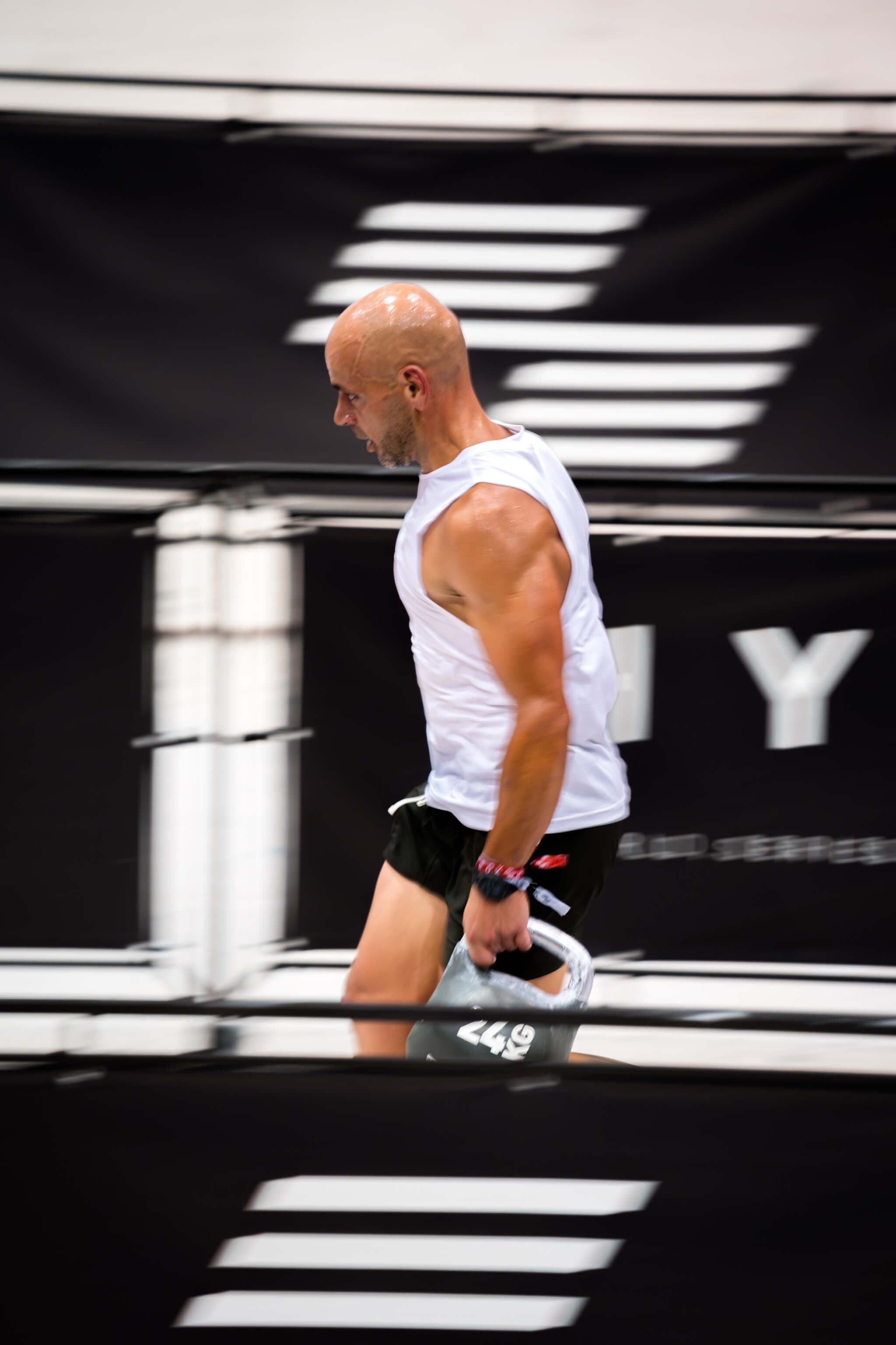 RoxZone athlete performing farmer carry at HYROX event