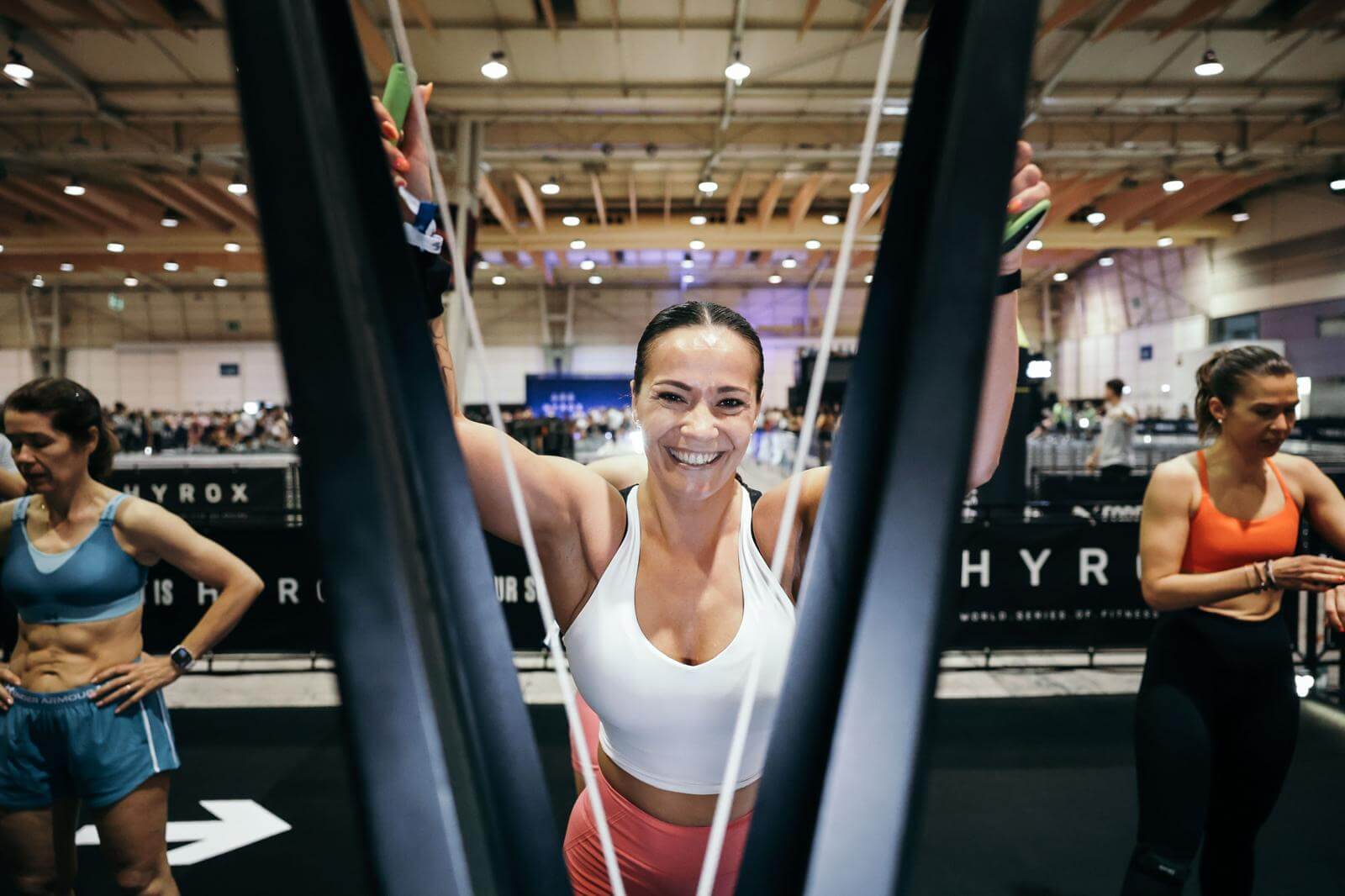 RoxZone female athlete on ski erg at HYROX race