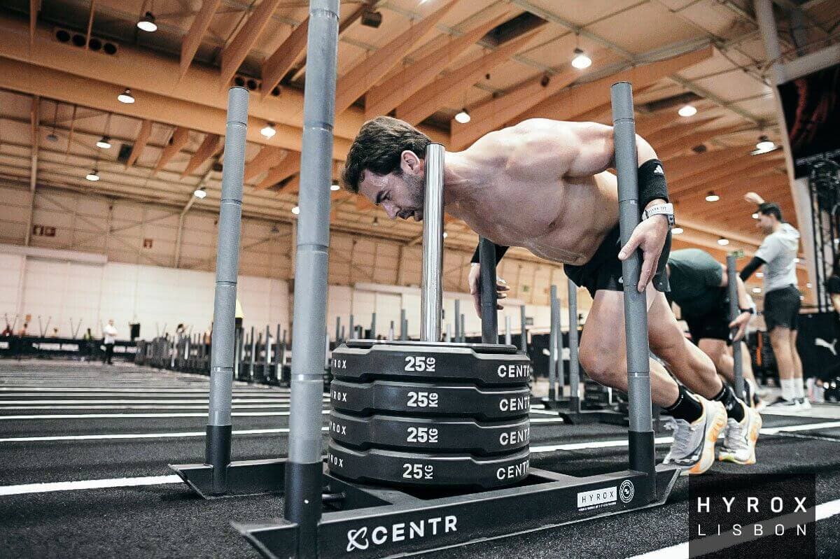 RoxZone athlete performing sled push at HYROX race