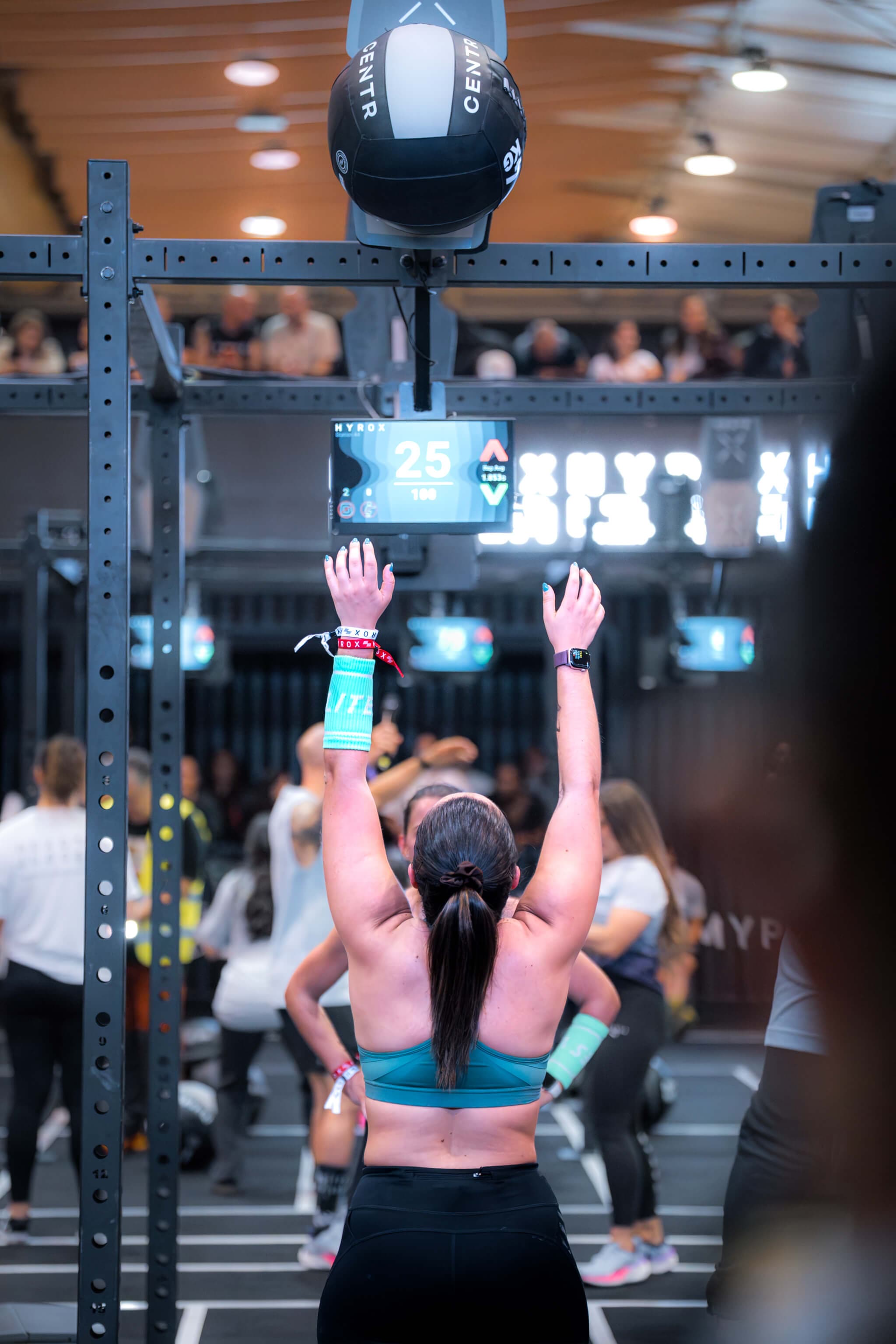RoxZone athlete performing wall balls during HYROX competition