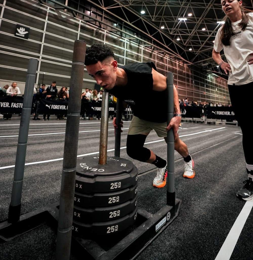Athlete performing the HYROX sled push during a race