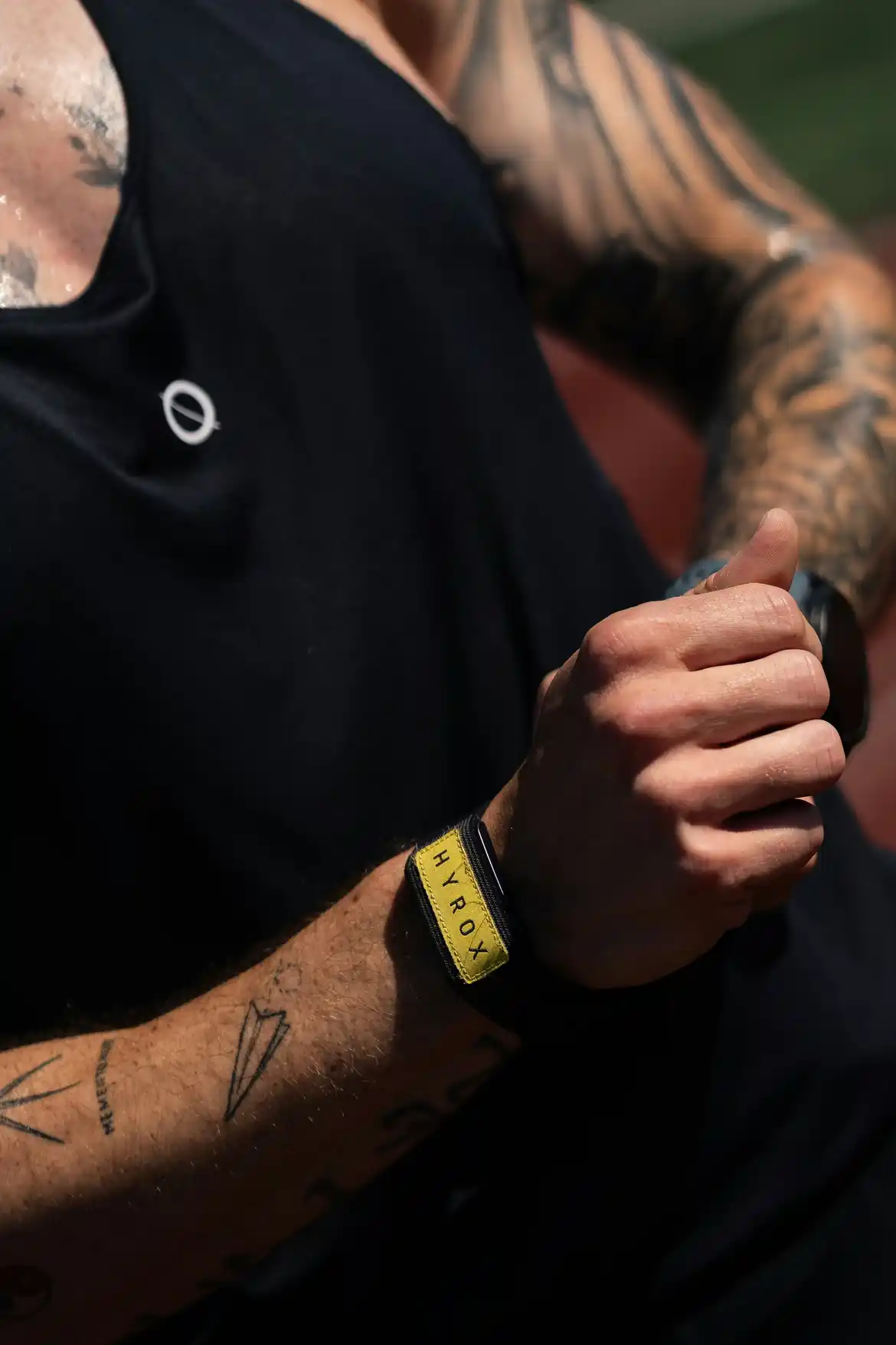 Athlete using HYROX training methodology with wristband during hybrid session