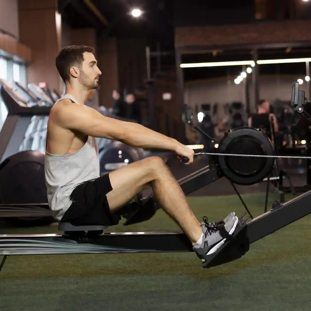 Man training on rowing machine as part of Deka Fit workout plan