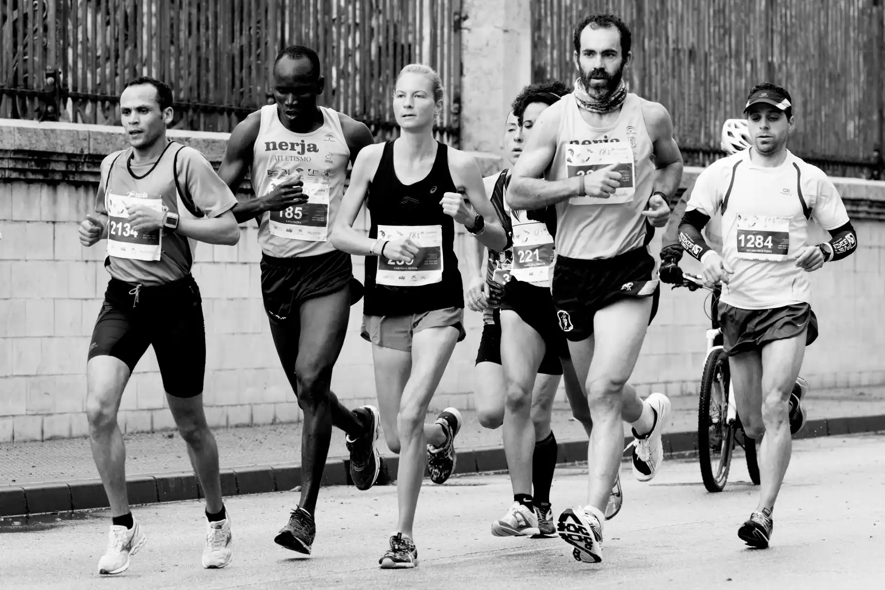 Group of endurance athletes running in a race, representing the role of cardio in the interference effect with strength training.